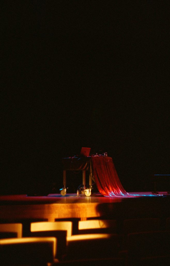 A table on stage with a red cloth.